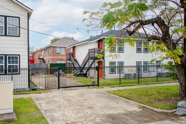 a view of a house with a yard and sitting area