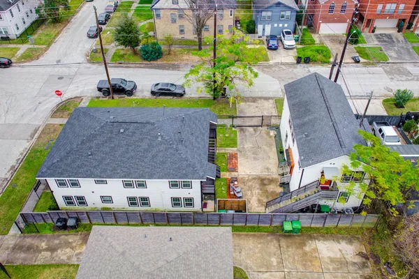 an aerial view of a house with a yard and sitting area
