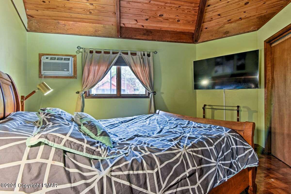 122 Elgin Way Bushkill, PA 18324 - Photo 11 of 32 a bedroom with a bed and a flat screen tv