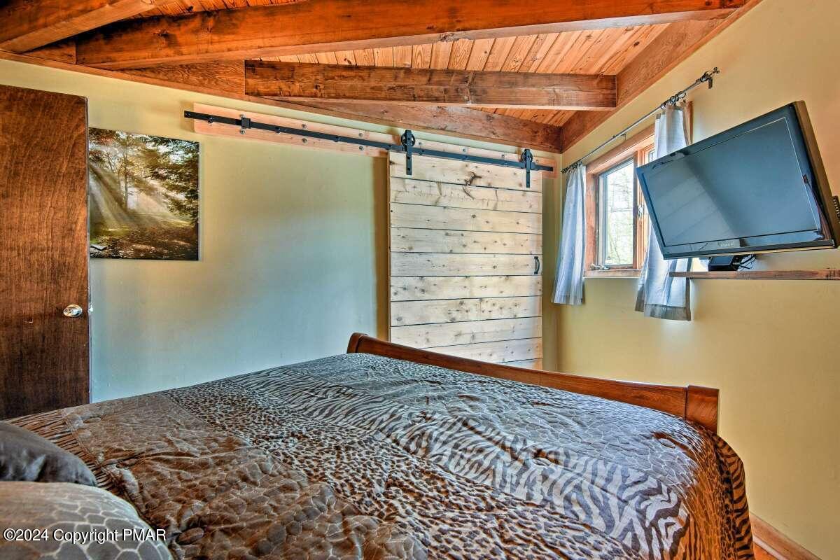 122 Elgin Way Bushkill, PA 18324 - Photo 14 of 32 a bedroom with a bed and a flat screen tv
