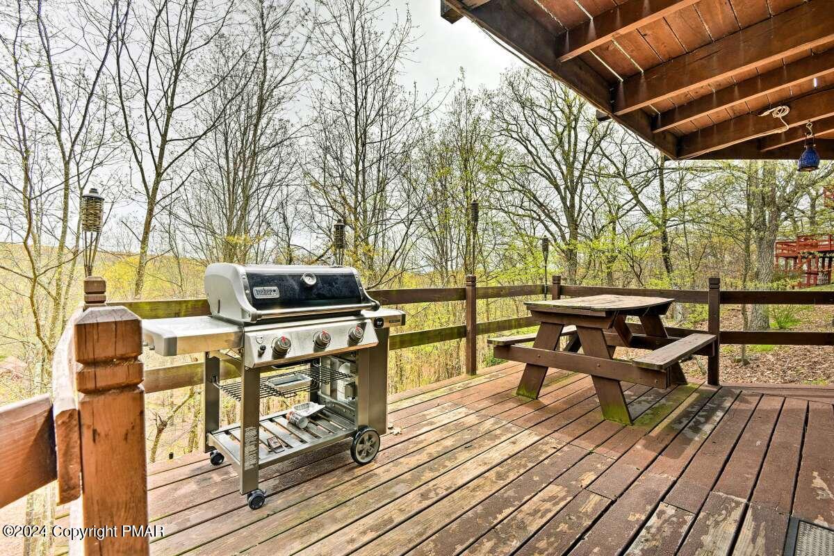 122 Elgin Way Bushkill, PA 18324 - Photo 19 of 32 a roof deck with a table and chairs