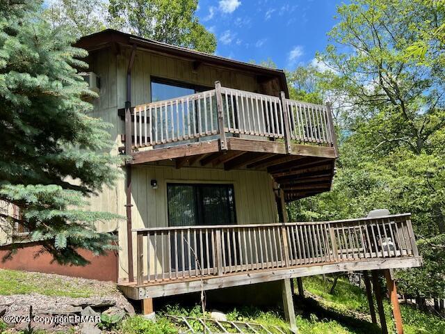 122 Elgin Way Bushkill, PA 18324 - Photo 25 of 32 a view of a brick house with wooden deck and furniture