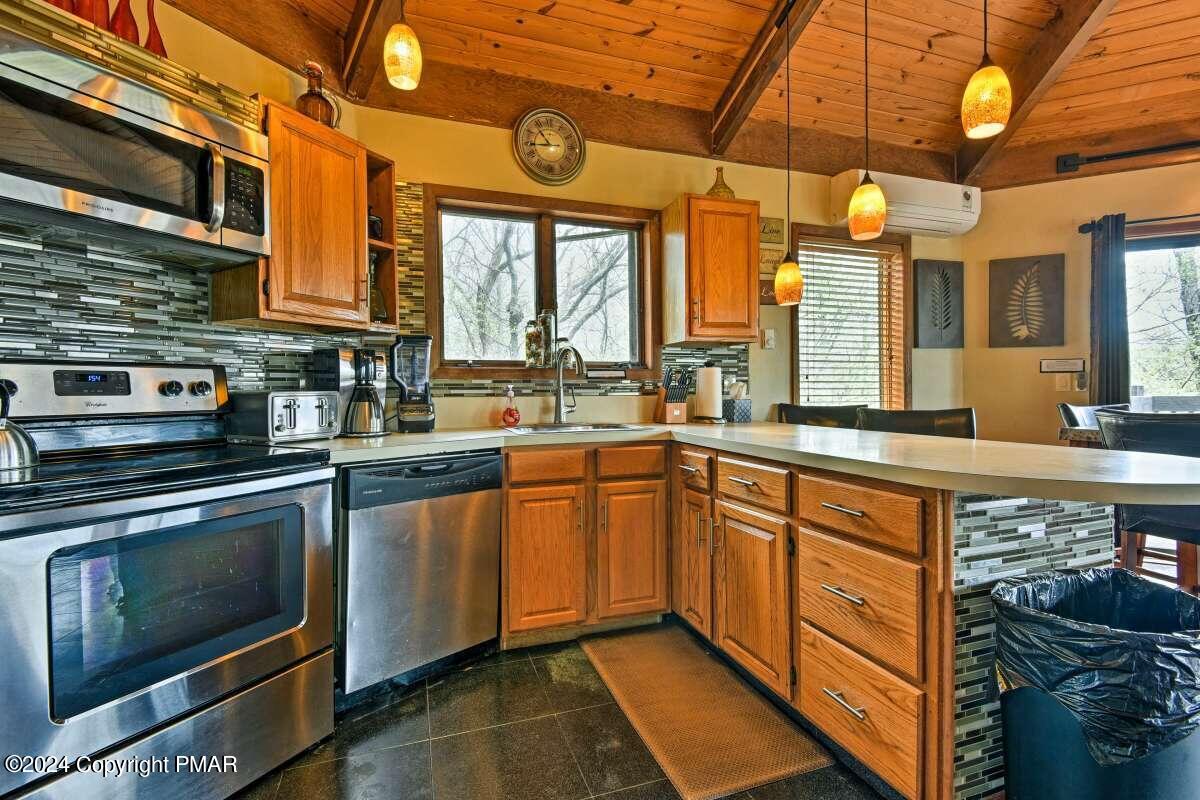 122 Elgin Way Bushkill, PA 18324 - Photo 7 of 32 a kitchen with stainless steel appliances granite countertop a stove and a sink