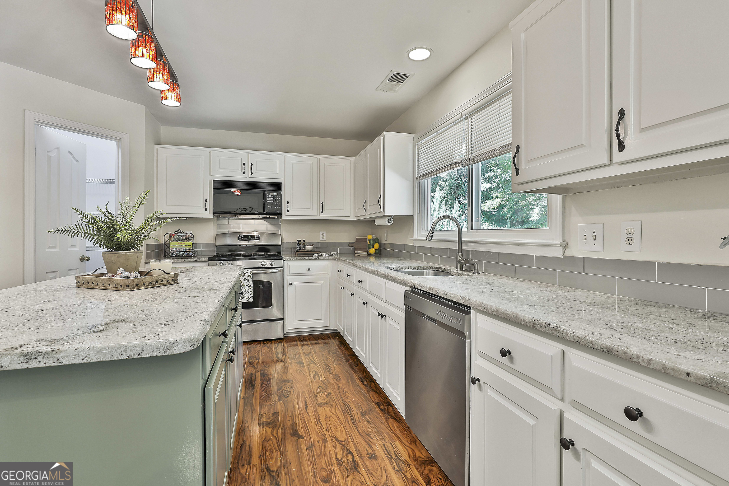 244 Terrane Ridge Peachtree City, GA 30269 - Photo 16 of 44 a kitchen with appliances a sink and cabinets