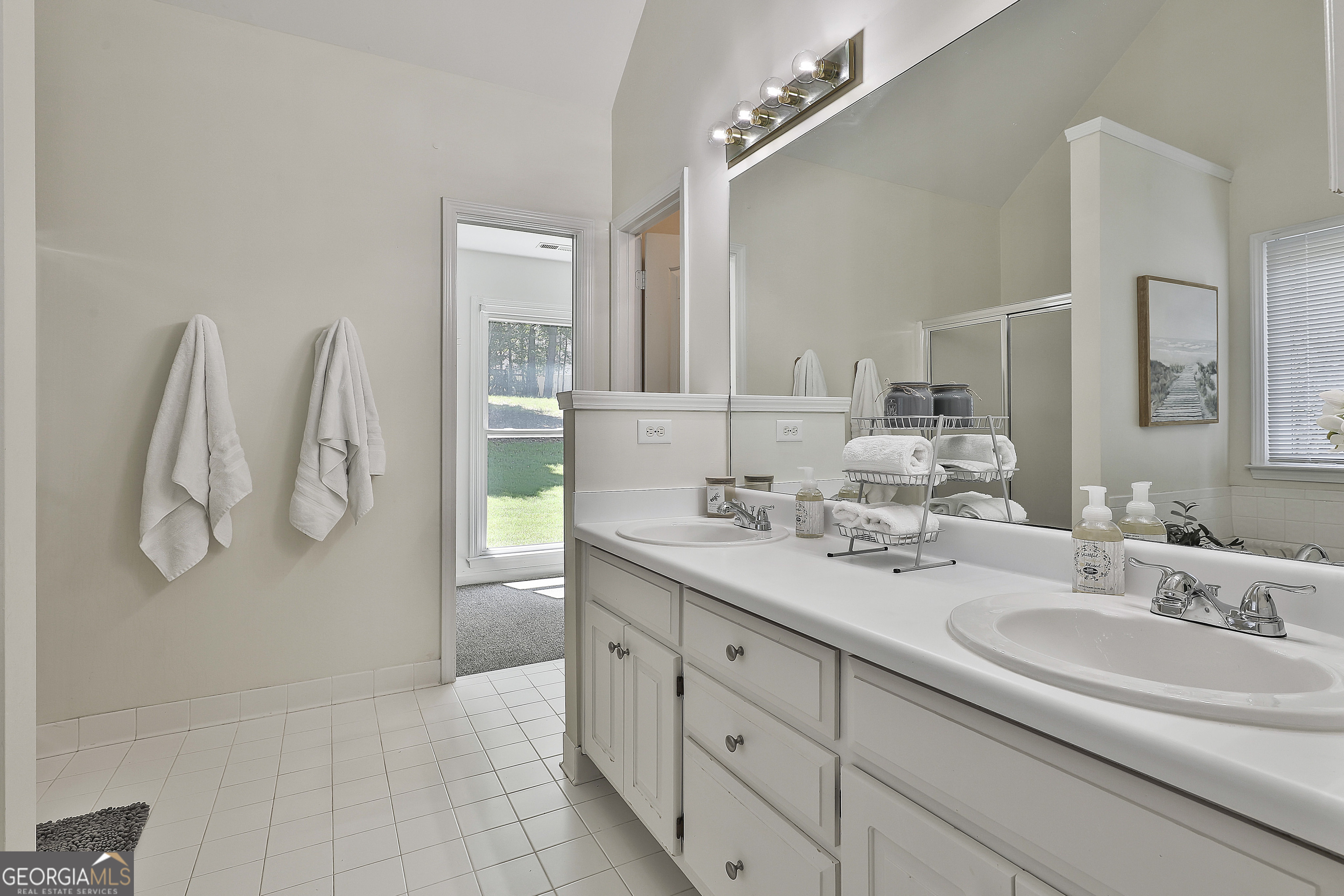 244 Terrane Ridge Peachtree City, GA 30269 - Photo 20 of 44 a spacious bathroom with a double vanity sink and a mirror