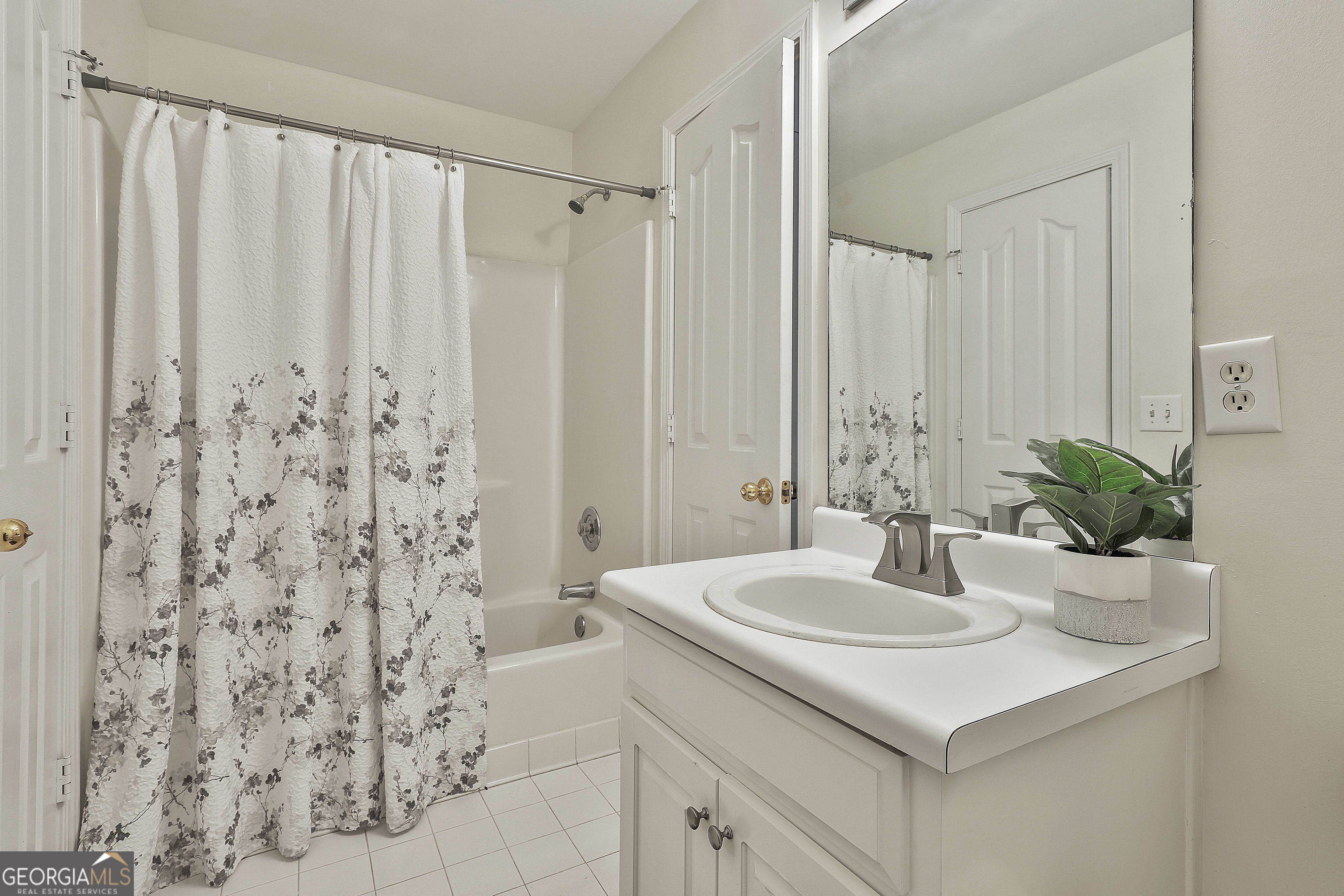 244 Terrane Ridge Peachtree City, GA 30269 - Photo 25 of 44 a bathroom with a sink and a mirror