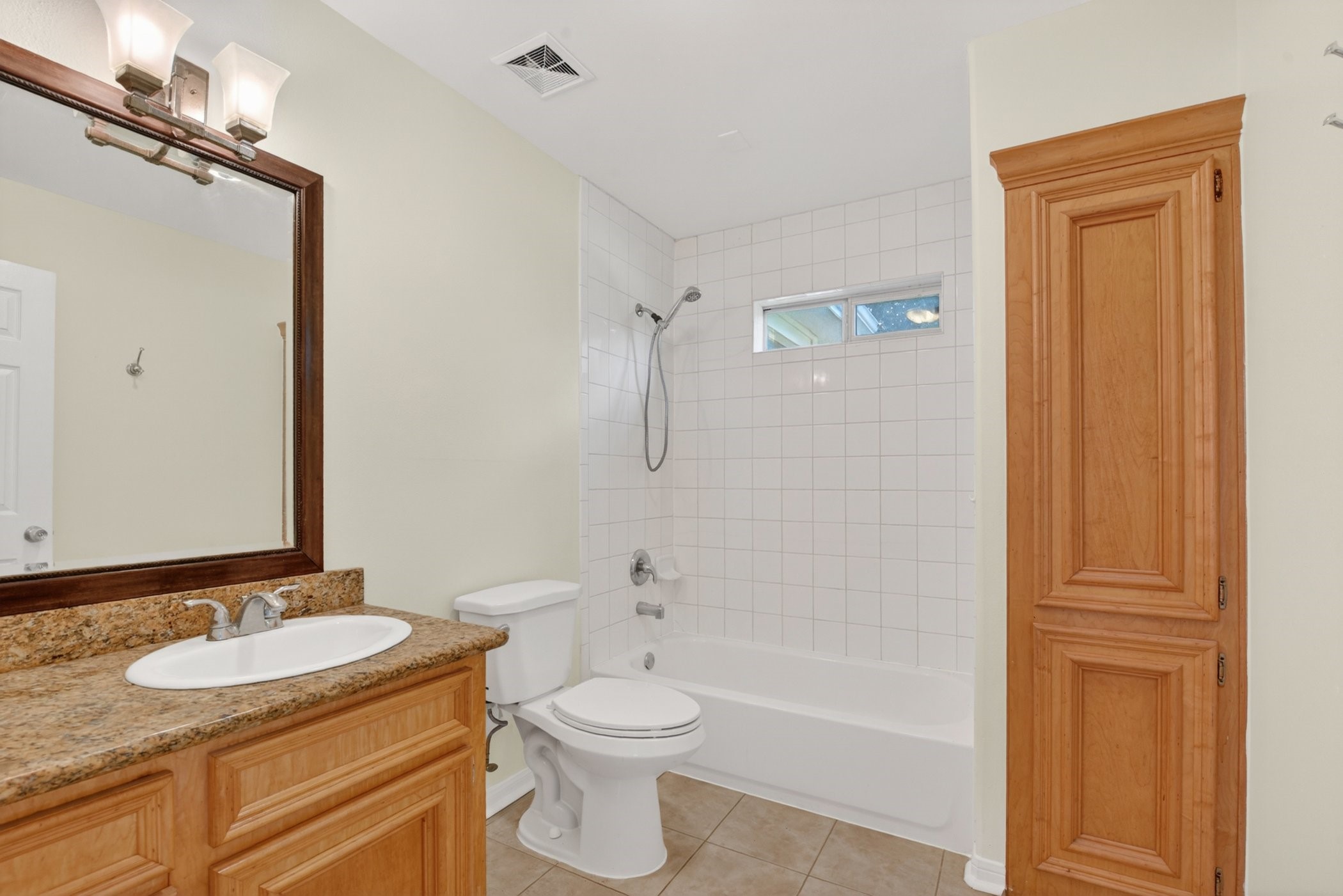 7013 St Augustine Street Houston, TX 77021 - Photo 26 of 35 a bathroom with a granite countertop sink toilet a mirror and shower