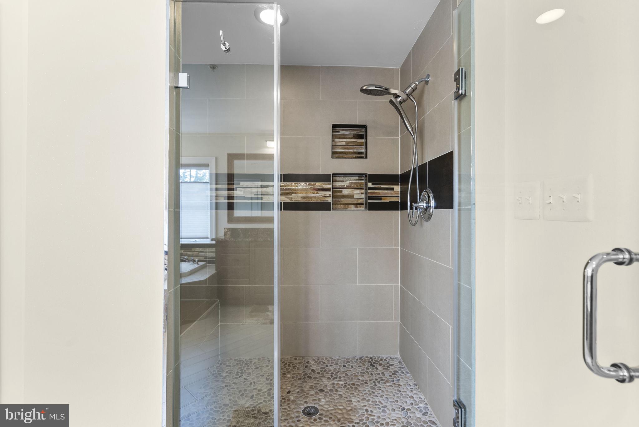4702 Edgefield Road Bethesda, MD 20814 - Photo 36 of 58 Sleek modern shower with elegant tiles.