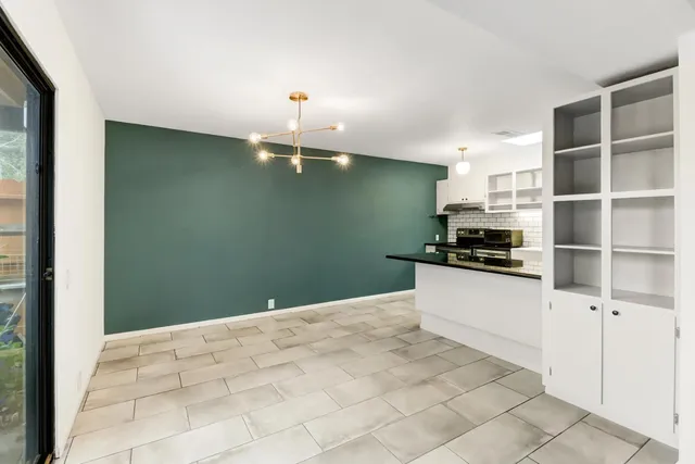 a kitchen with kitchen island sink and cabinets