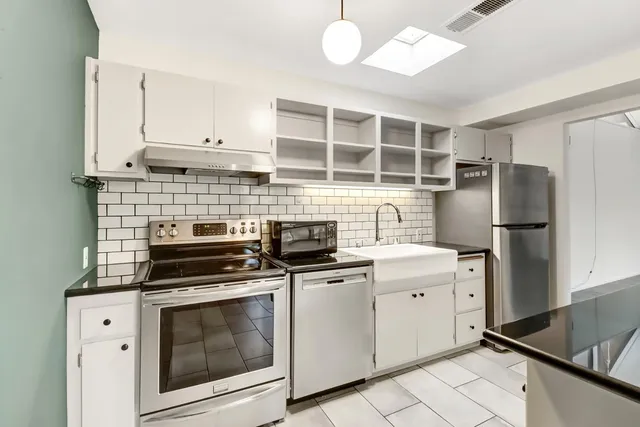 a kitchen with a stove microwave and refrigerator