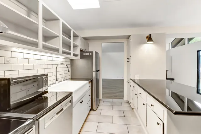 a kitchen with a stove and a refrigerator