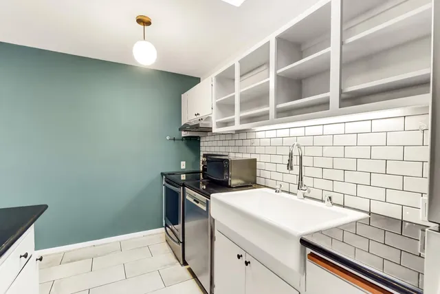 a view of a kitchen with a sink and cabinets