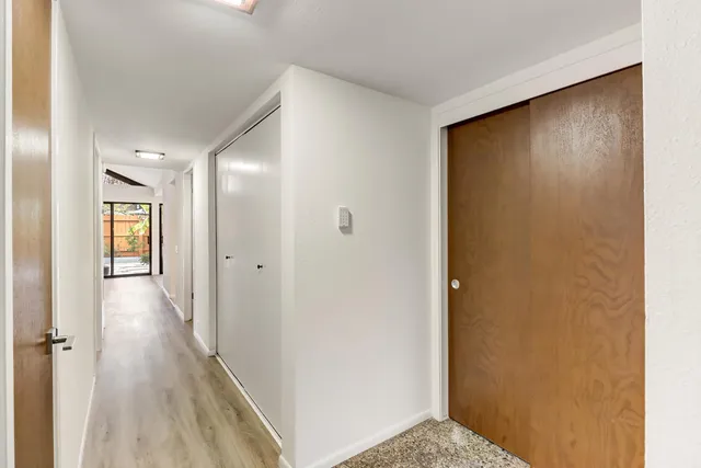 a view of a hallway with wooden floor