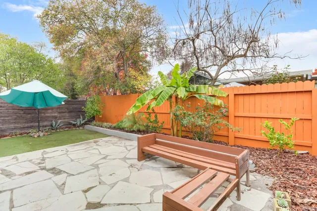 a backyard of a house with yard and outdoor seating
