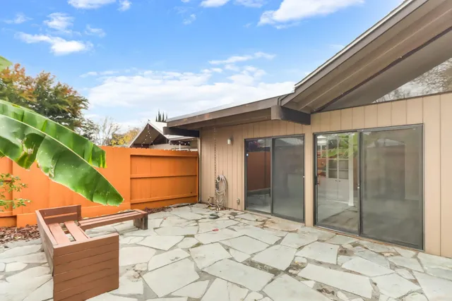a front view of a house with plants