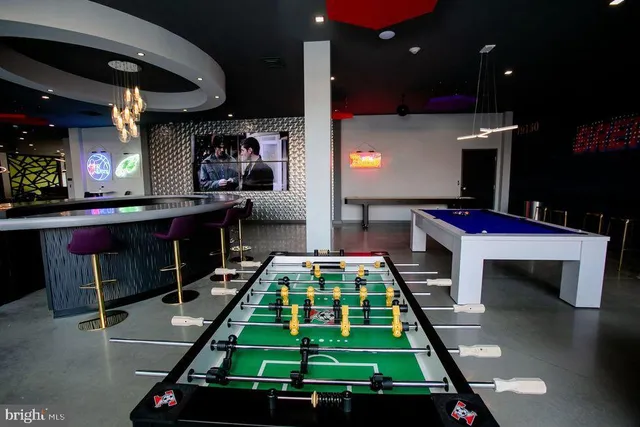 a living room with furniture and a book shelf