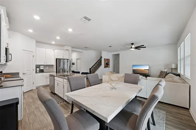 a view of kitchen with cabinets table and chairs