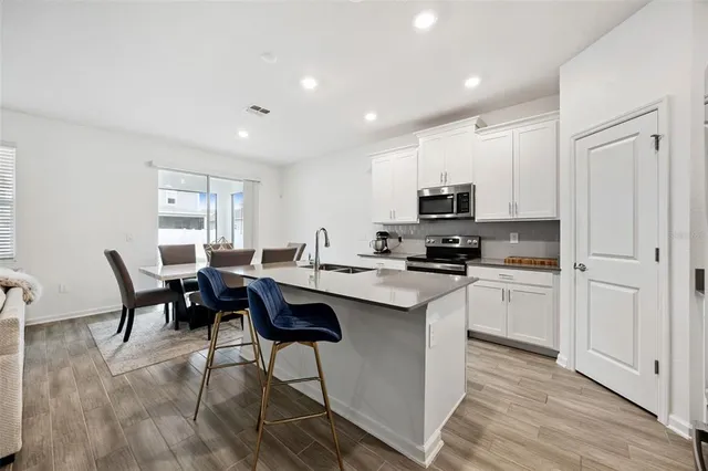 a view of a dining room with furniture and wooden floor