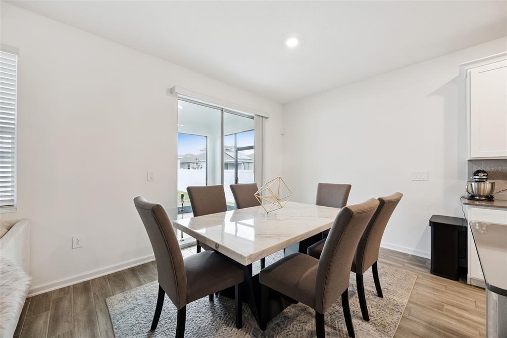 2747 Slash Way St. Cloud, FL 34771 - Photo 16 of 62 a view of a dining room with furniture and wooden floor