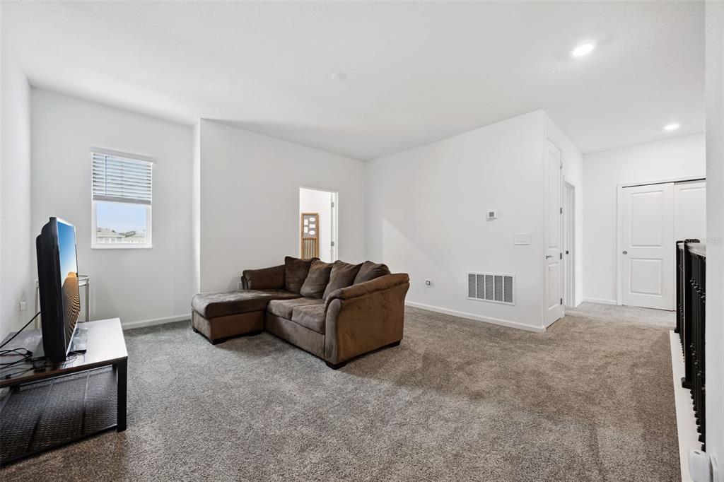 2747 Slash Way St. Cloud, FL 34771 - Photo 24 of 62 a living room with furniture and a flat screen tv