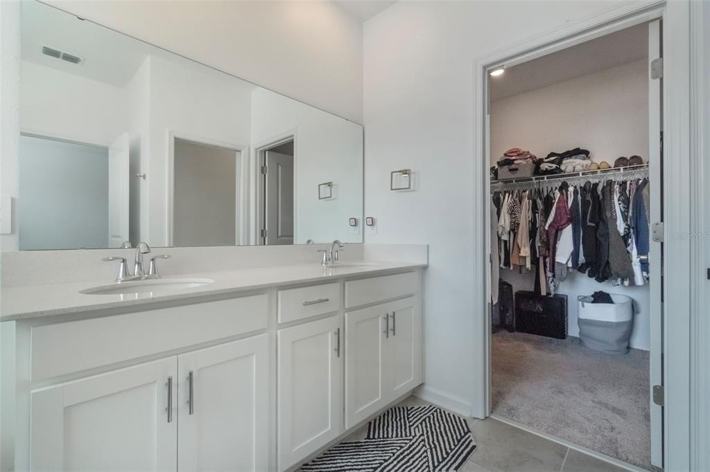 2747 Slash Way St. Cloud, FL 34771 - Photo 30 of 62 a bathroom with a double vanity sink and a mirror