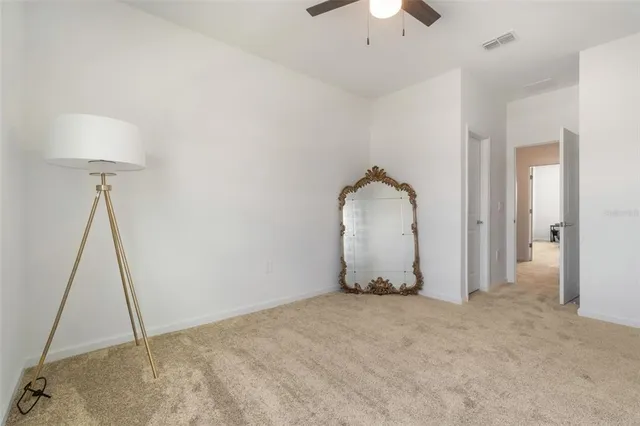 a bathroom with a granite countertop sink toilet and mirror