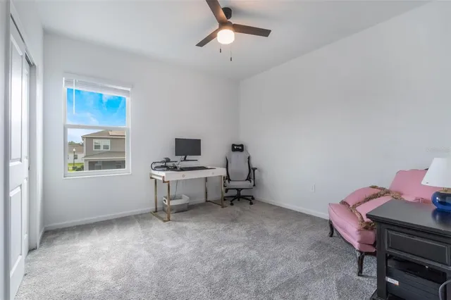 a large bedroom with a bed and glass door