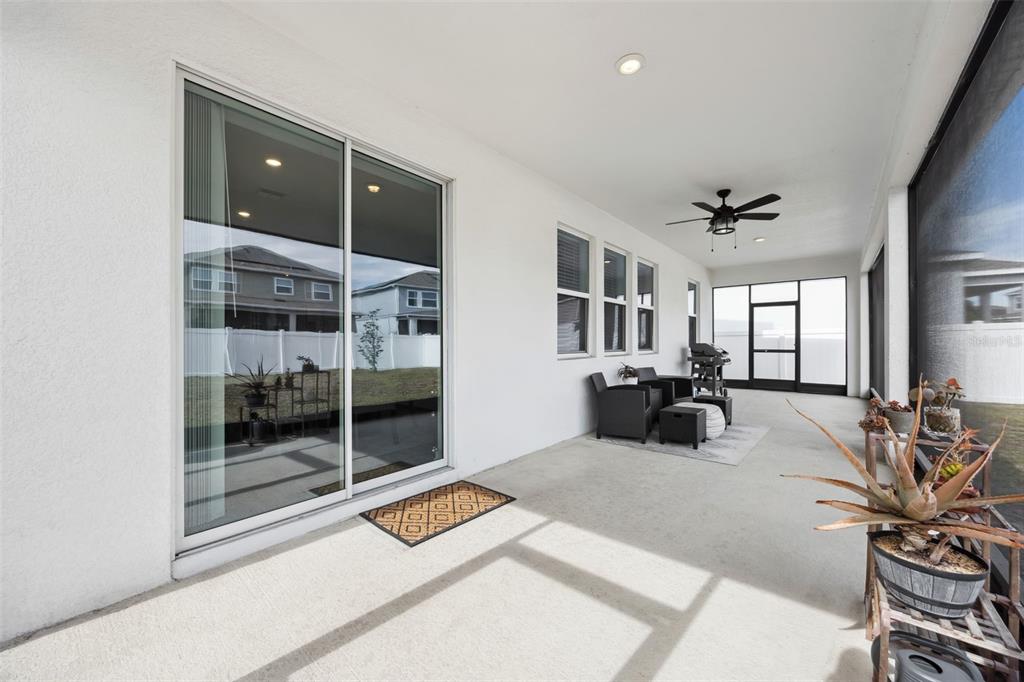 2747 Slash Way St. Cloud, FL 34771 - Photo 40 of 62 a large bedroom with a bed and glass door