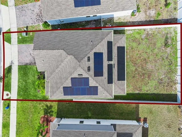 an aerial view of residential building and lake