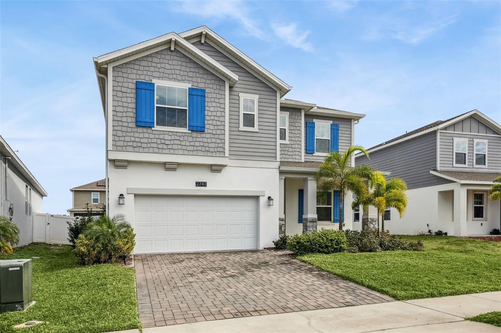 2747 Slash Way St. Cloud, FL 34771 - Photo 5 of 62 a front view of a house with a yard and garage