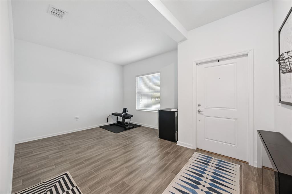 2747 Slash Way St. Cloud, FL 34771 - Photo 7 of 62 a view of a room with wooden floor and bedroom