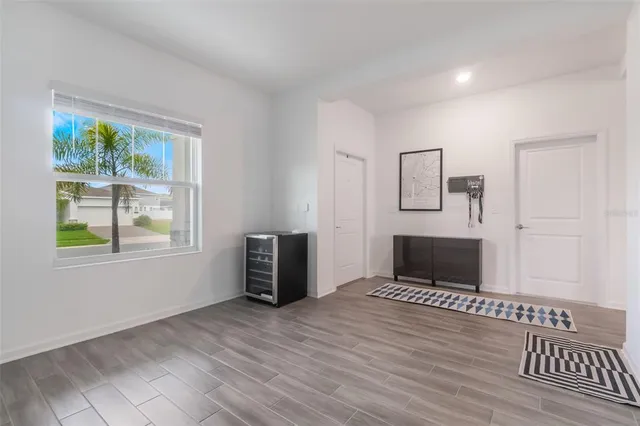 a view of a livingroom with wooden floor and furniture