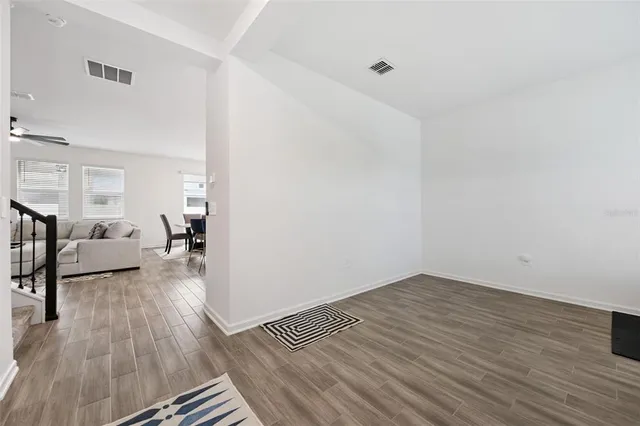 a kitchen with white cabinets and sink