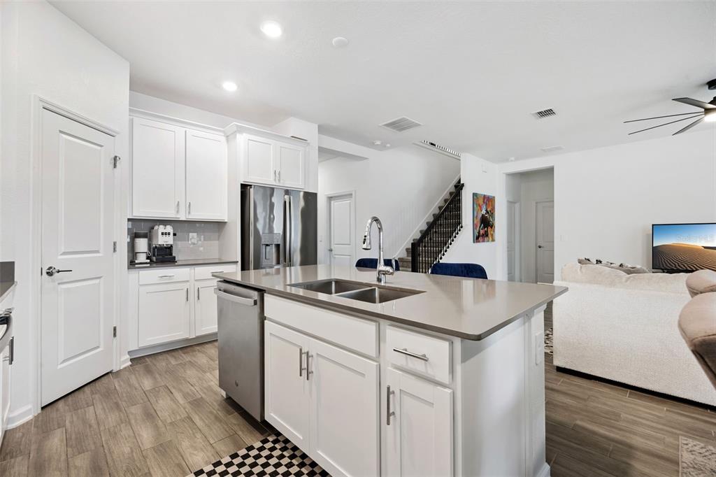 2747 Slash Way St. Cloud, FL 34771 - Photo 10 of 62 a kitchen with white cabinets and sink