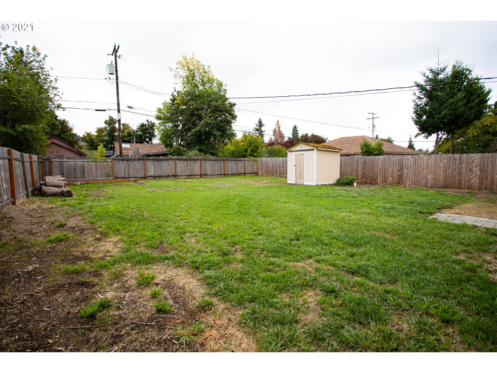 1231 D Street Springfield, OR 97477 - Photo 14 of 14 a view of a yard with a fence and trees