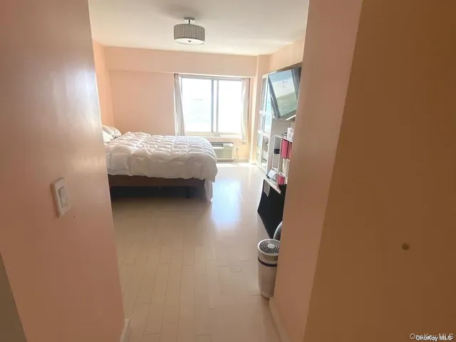 a bed sitting in a bedroom next to a window