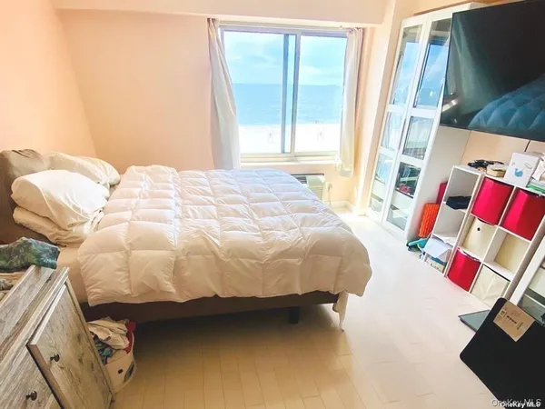 a bedroom with a bed and a window