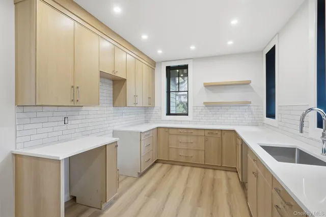 a large kitchen with a sink and cabinets