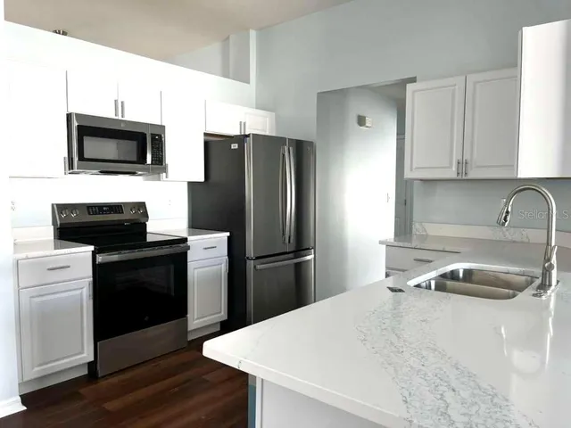 a kitchen with a refrigerator stove and microwave
