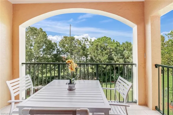 a view of a balcony with a table and chairs