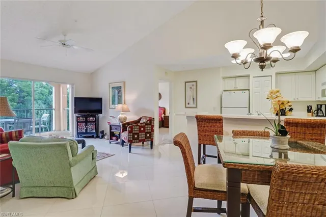 a living room with fireplace furniture and a chandelier