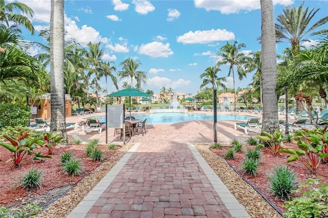 a view of a pathway with a flower garden