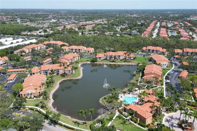 an aerial view of lake and residential houses with outdoor space