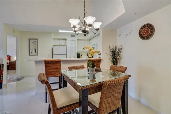 a dining room with furniture a chandelier and window