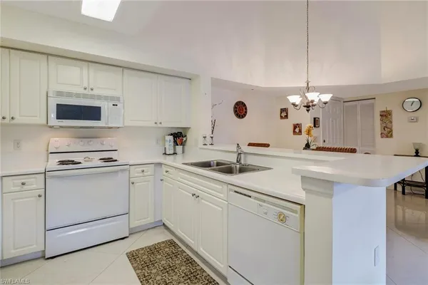 a kitchen with a sink stove and microwave
