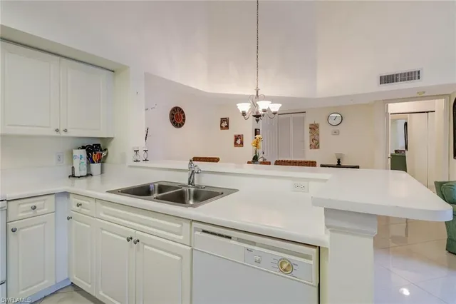a kitchen with a sink and refrigerator