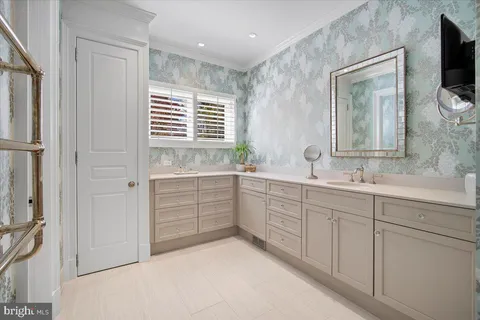 a spacious bedroom with a bed couch and large window