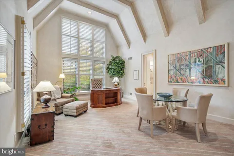 a living room with lots of furniture and a window