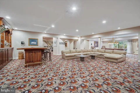 a dining room with furniture a chandelier and wooden floor