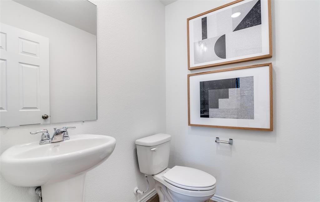 2109 Sugar Maple Lane Forney, TX 75126 - Photo 18 of 22 a bathroom with a toilet sink and mirror